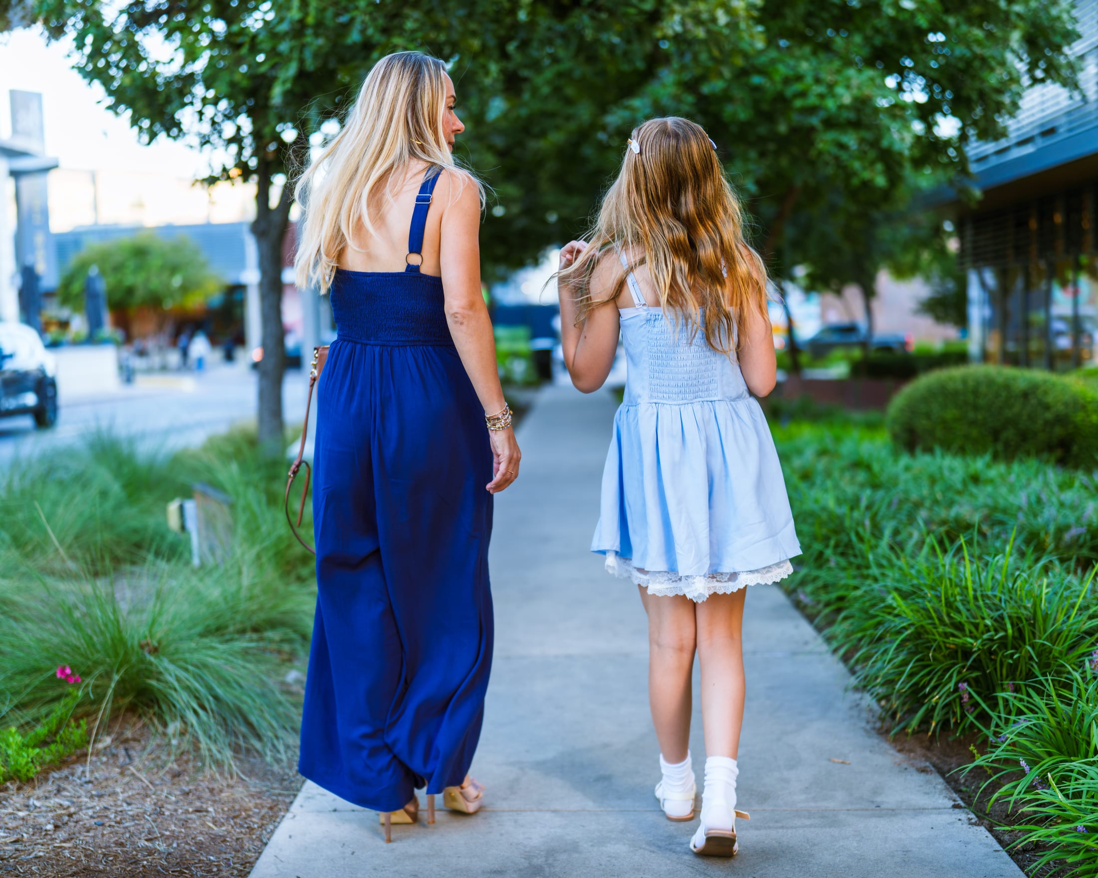 Mother and daughter walking down an Austin street.